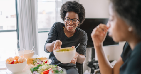 Two women eating plant-based food