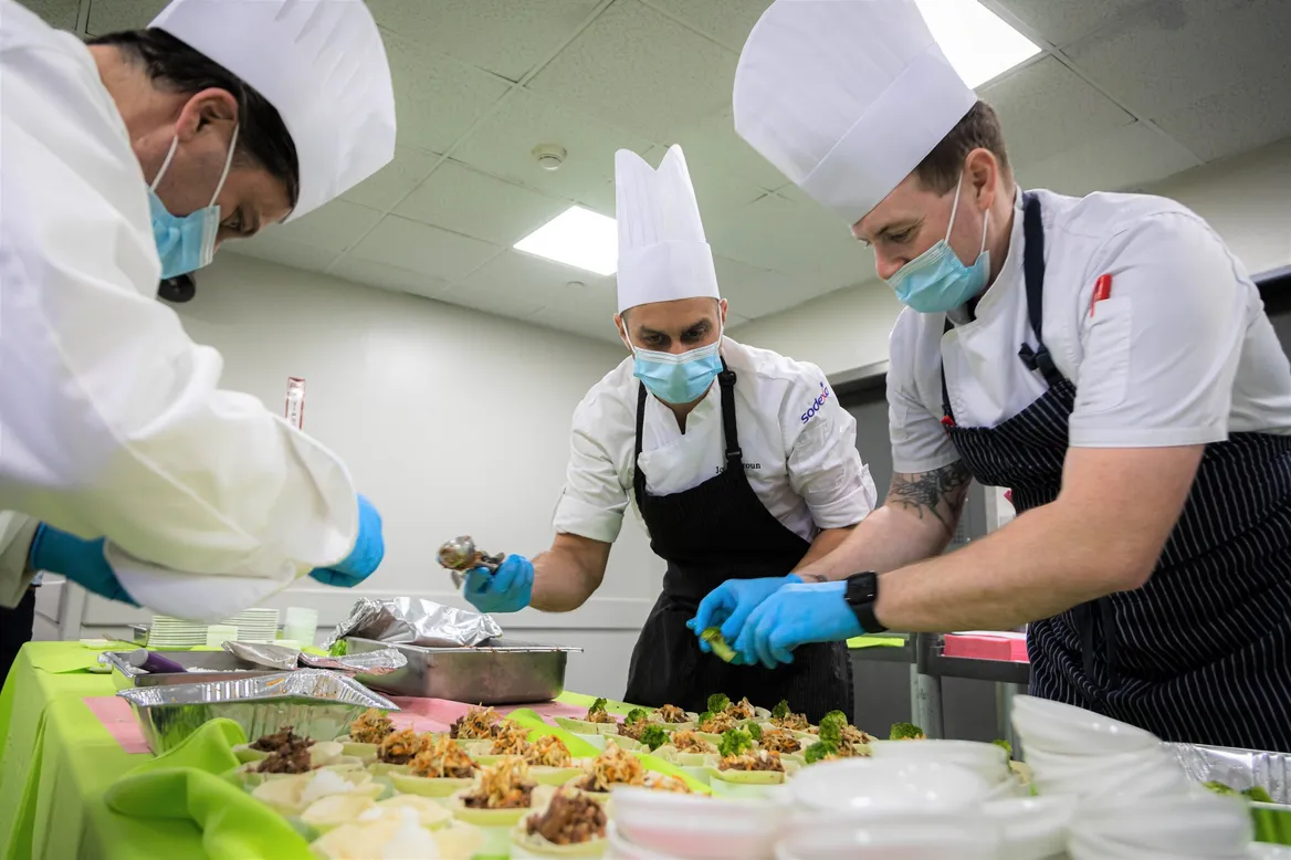 Staff making tasty veggie meals at the hospital system's culinary center