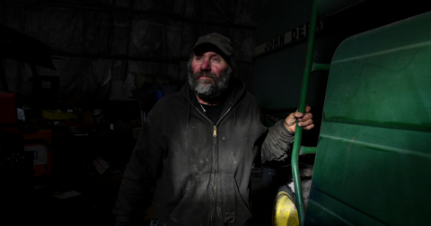 A farmer Bob Krocak poses for a portrait while in his shop repairing equipment